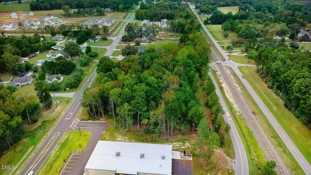 a view of swimming pool with a garden and trees