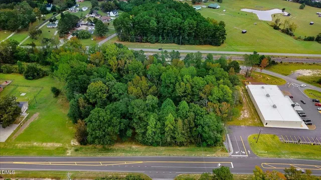 an aerial view of a residential houses with yard
