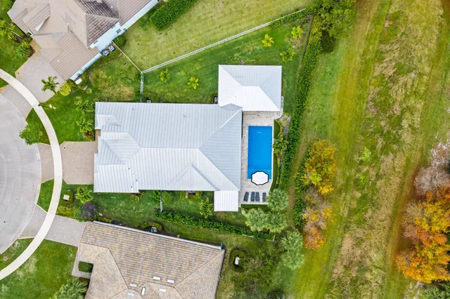 an aerial view of a house with a yard