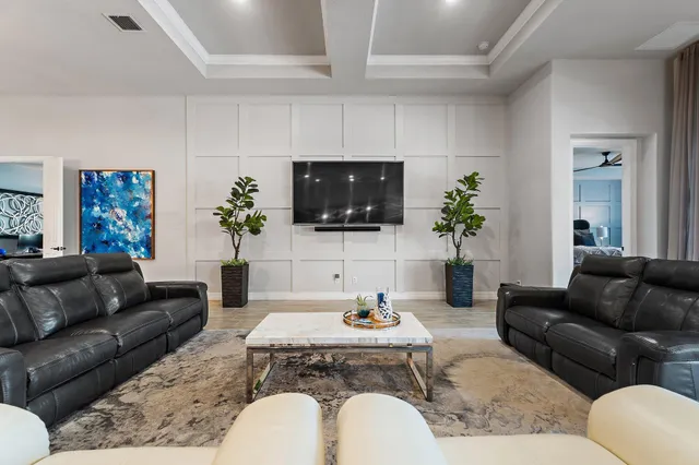 a kitchen with stainless steel appliances kitchen island granite countertop a table chairs microwave and refrigerator