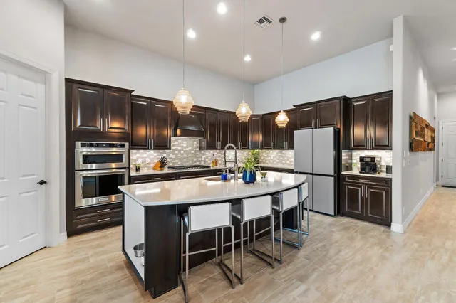 a kitchen with stainless steel appliances granite countertop a stove and a refrigerator