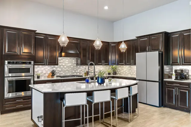 a kitchen with lots of counter top space and stainless steel appliances