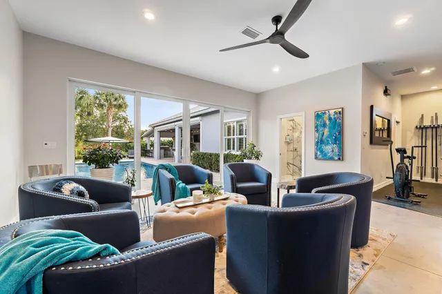 a view of a house with swimming pool and sitting area