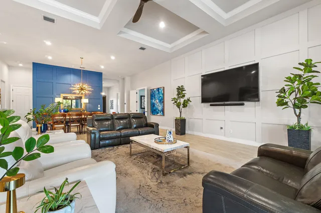 a kitchen with stainless steel appliances kitchen island granite countertop a refrigerator a stove a microwave oven a sink with island and chairs