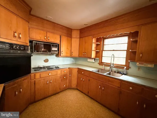 a kitchen with stainless steel appliances granite countertop a sink stove and microwave