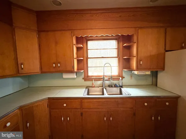 a kitchen with a sink cabinets and window