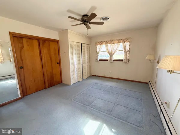 a view of a livingroom with a ceiling fan and window
