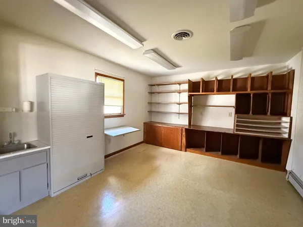 a kitchen with stainless steel appliances a large window and a refrigerator