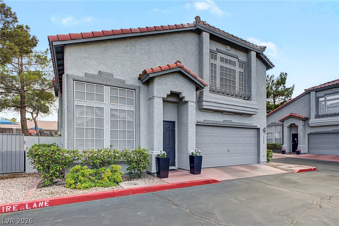 Spanish tile accents and classic stucco design create an inviting exterior facade.