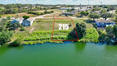 an aerial view of residential houses with outdoor space and swimming pool