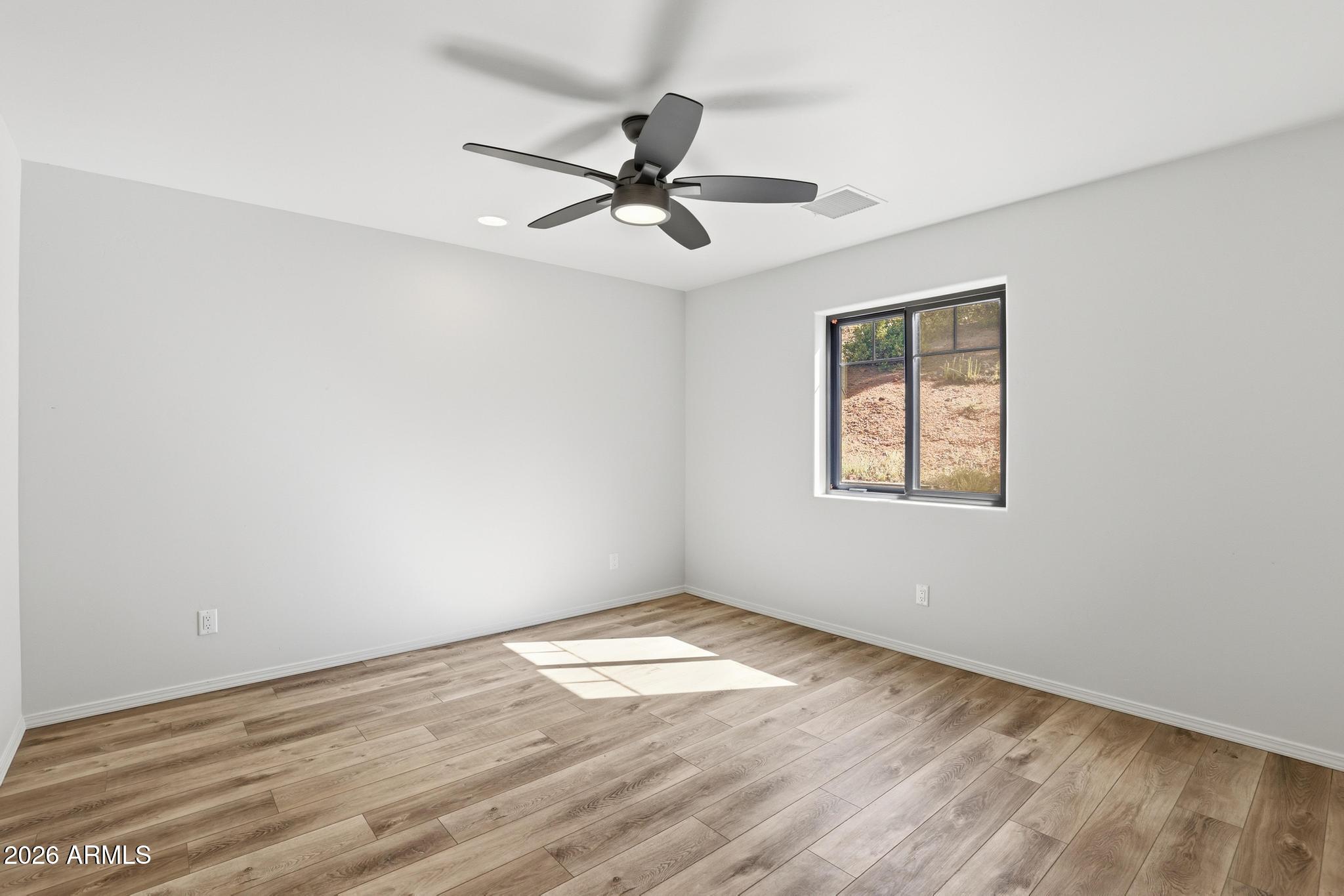 1908 East Starlight Pass Payson, AZ 85541 - Photo 26 of 30 an empty room with wooden floor fan and windows