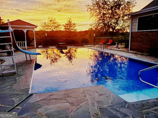an aerial view of a house with a yard and lake view