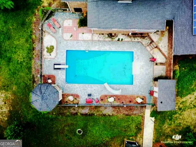 a view of a patio with a dining table and chairs