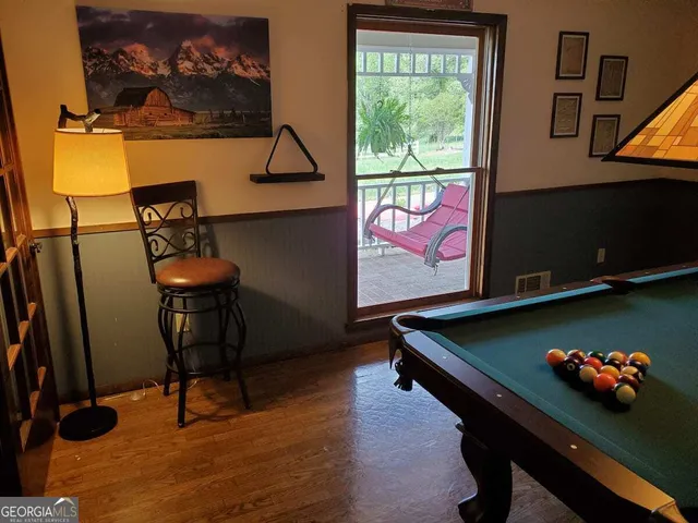 a view of a chairs and table in the balcony