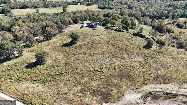 a view of a house with swimming pool and sitting area