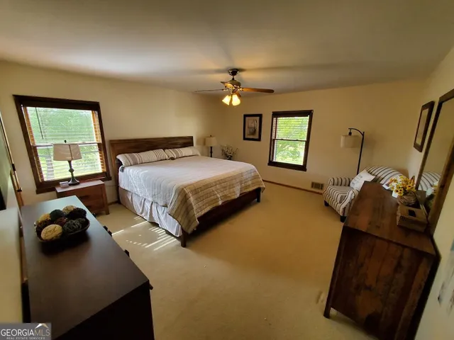 a backyard of a house with lots of green space and outdoor seating