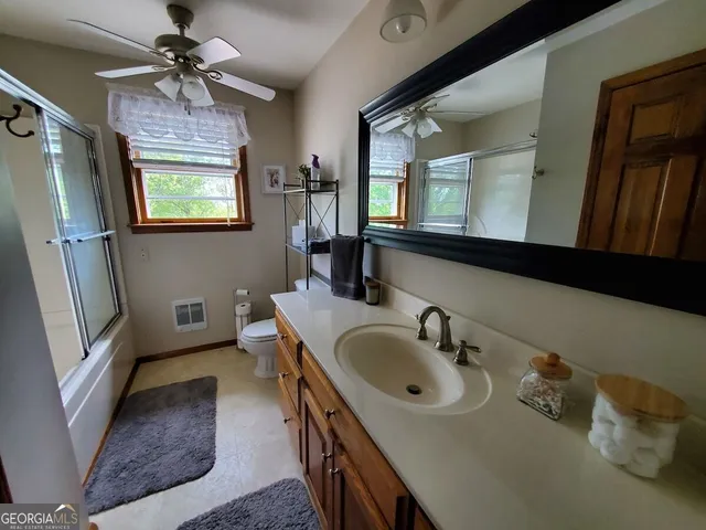 a view of a patio with table and chairs with wooden floor and fence