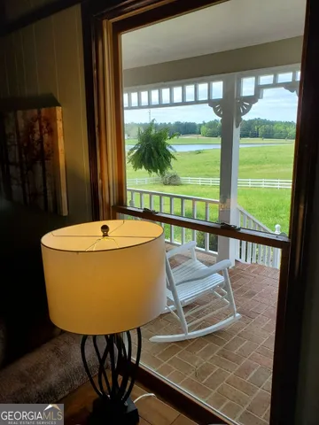 a large white bed in a bedroom next to a window
