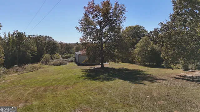 a view of a white house with a sink and yard