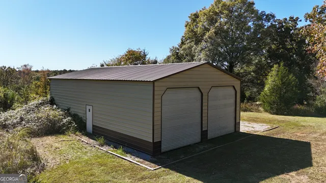an aerial view of a house with a yard and lake view