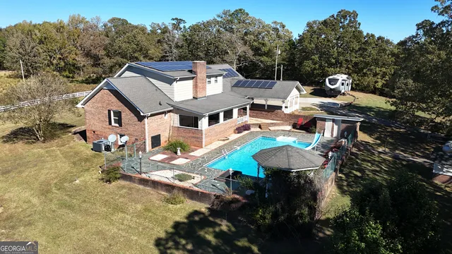 a large kitchen with stainless steel appliances granite countertop a sink counter space cabinets and a large window
