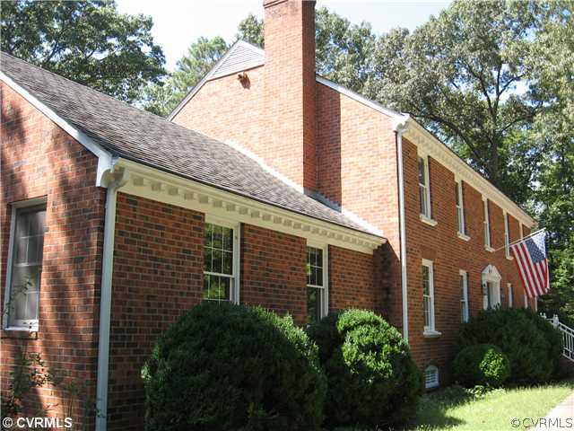 10930 Cherrybark Road Chester, VA 23831 - Photo 4 of 14 a view of a large brick building next to a yard