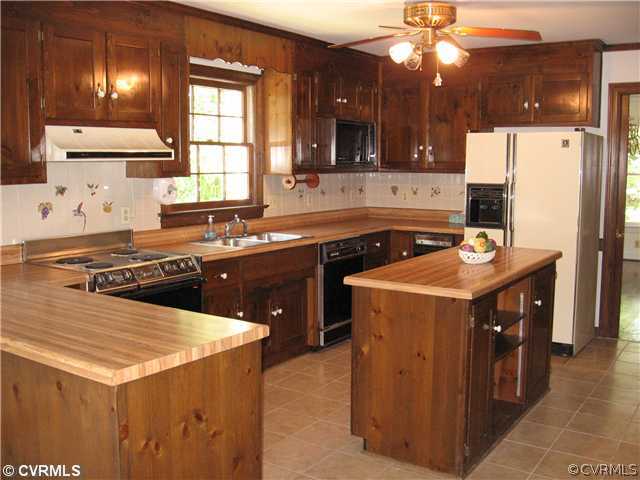 10930 Cherrybark Road Chester, VA 23831 - Photo 10 of 14 a kitchen with a stove a sink a refrigerator and a microwave