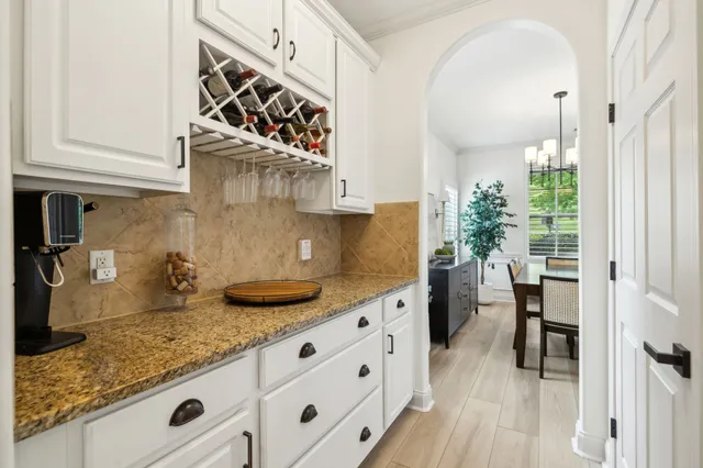 a kitchen with granite countertop a sink a stove and wooden floor
