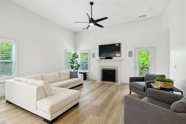 a living room with furniture a fireplace and a flat screen tv