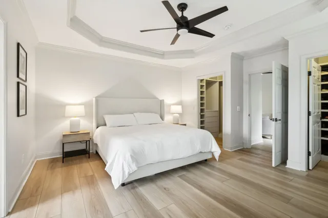 a bedroom with a bed and a ceiling fan