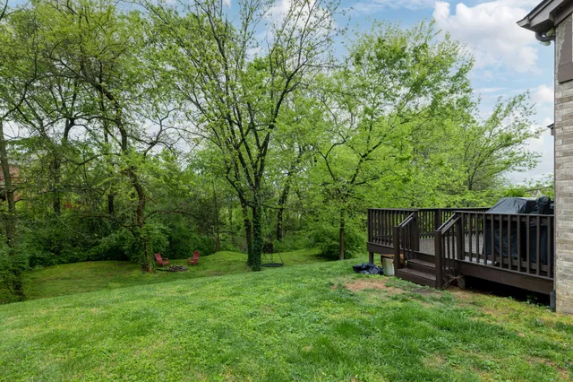 a view of backyard with a small cabin and wooden fence