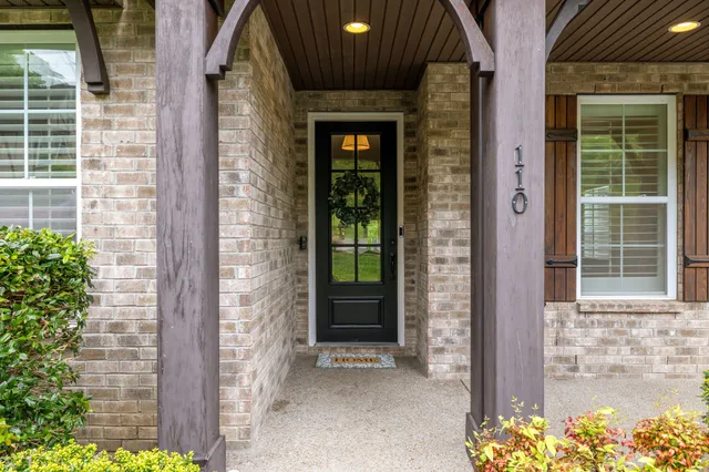 a couple of potted plants in front of door