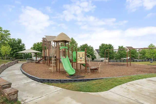 a view of a park with swings and slides