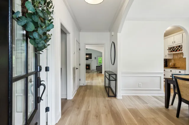 a view of a hallway with wooden floor and staircase