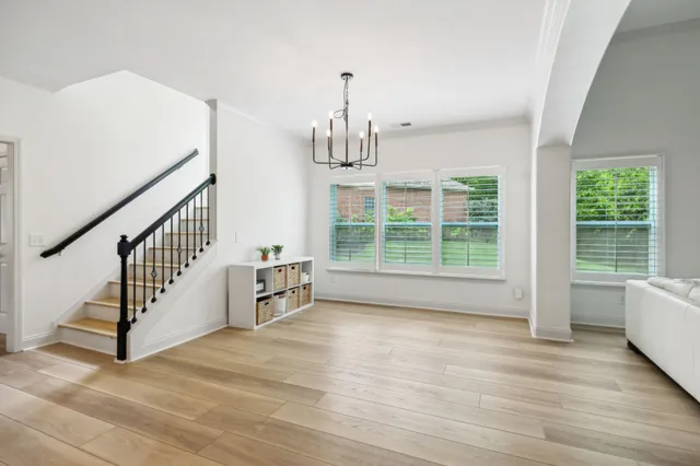 a view of entryway and hall with wooden floor