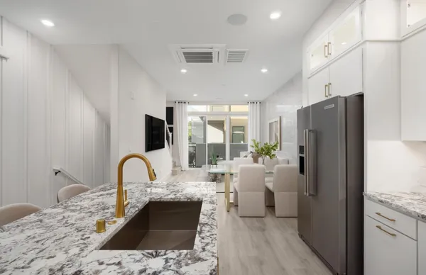 a kitchen with a refrigerator and a sink