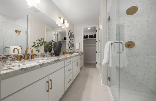 a bathroom with a granite countertop sink mirror and shower