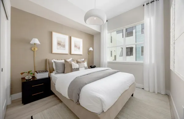 a bedroom with bed and wooden floor