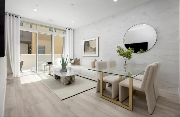 a living room with furniture and wooden floor