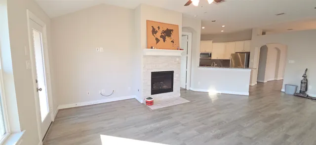 a view of livingroom with hardwood floor and kitchen view
