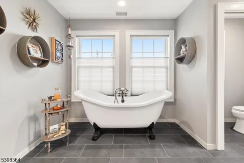 a bathroom with a sink a bathtub and a window