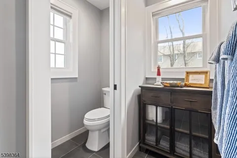 a bathroom with a toilet a sink and a window