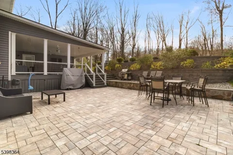 a view of a patio with table and chairs and potted plants