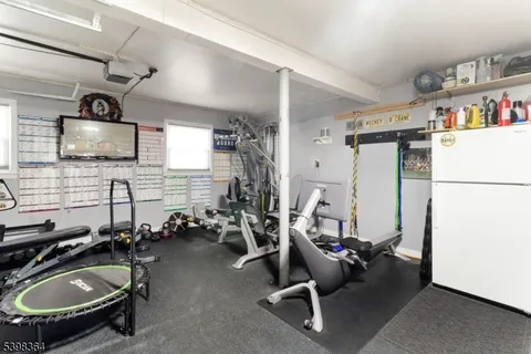 a room with gym equipment and a flat screen tv