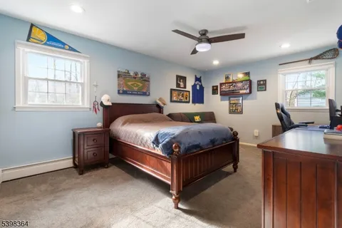 a bedroom with a bed couch and window