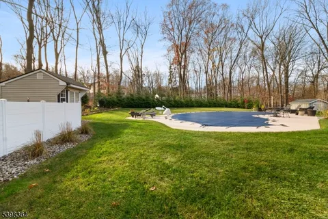 a view of yard with swimming pool and green space