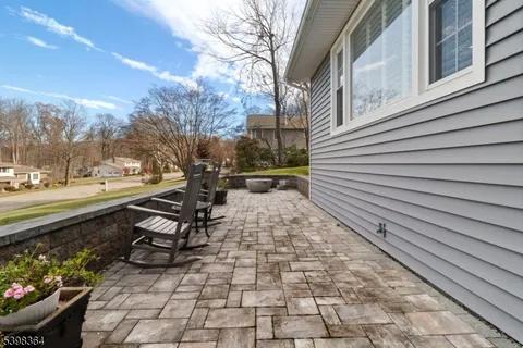 a view of an house with backyard and trees