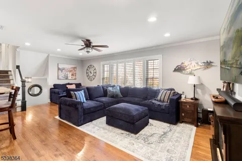 a living room with furniture a chandelier and a window