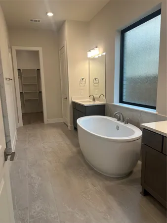 a spacious bathroom with a bathtub and a sink