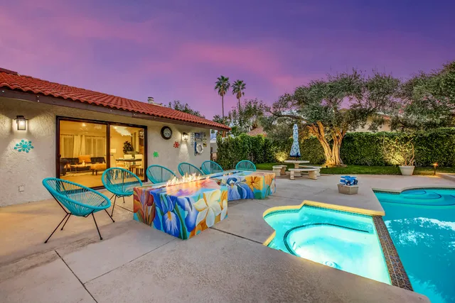 a view of a swimming pool and outdoor seating